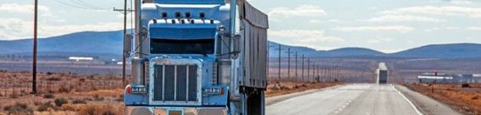 Semi truck driving on a straight road